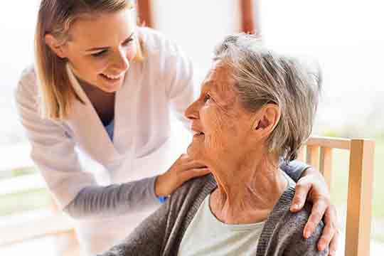 Health visitor and a senior woman during home visit. Health visitor and a senior woman during home visit.
