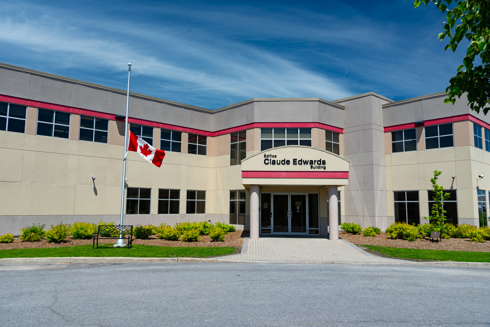 Canada’s national flag flying at half-mast during National Public Service Week at the Claude Edwards Building in Ottawa honouring the contributions of Canadian public servants who have passed away.