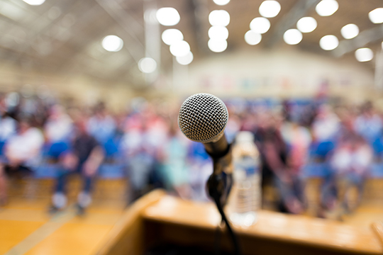 A microphone on a podium in an auditorium.