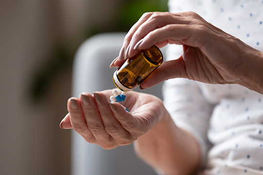 Hands holding a bottle of pills Hands holding a bottle of pills