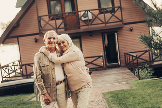 Couple standing in front of a house