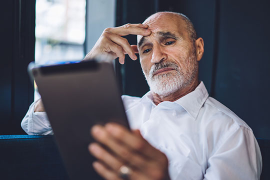 A man reading a tablet.