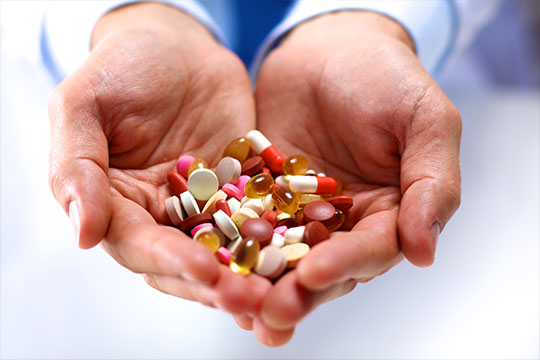 Hands holding pills Deprescribing network.