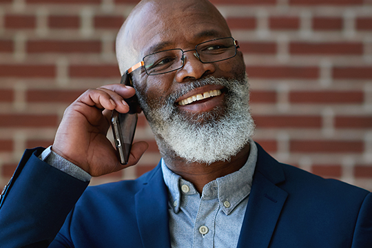 Contact Federal Retirees today! Man on a phone.