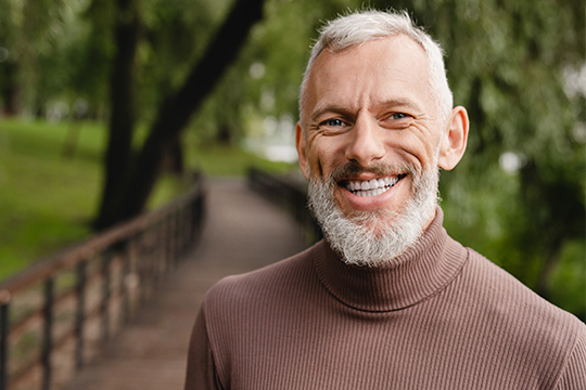 Volunteer smiling outdoors.