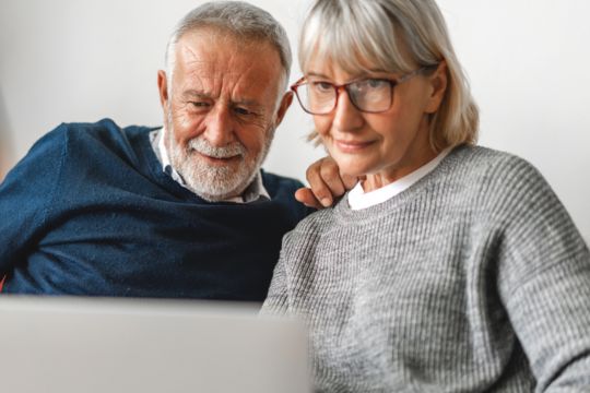Don’t forget to complete positive enrolment with Canada Life. Adult couple at computer.