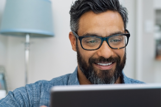 Adult man with tablet device.