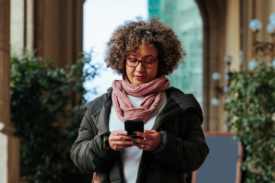 Adult woman using mobile phone.