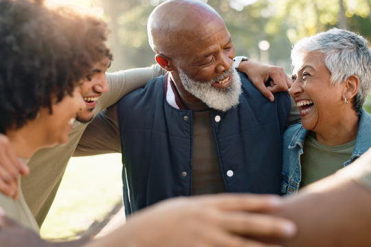 Share information and resources about women’s heart health. Smiling family spending time together outdoors.