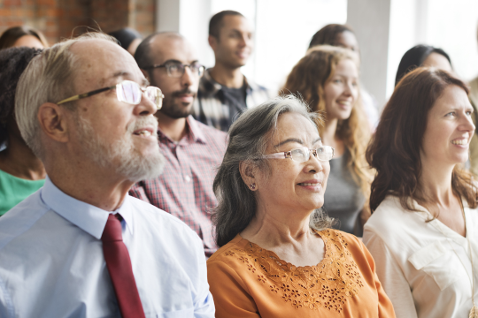 Federal Retirees’ membership and partners brochures. A group of adults at a community event.