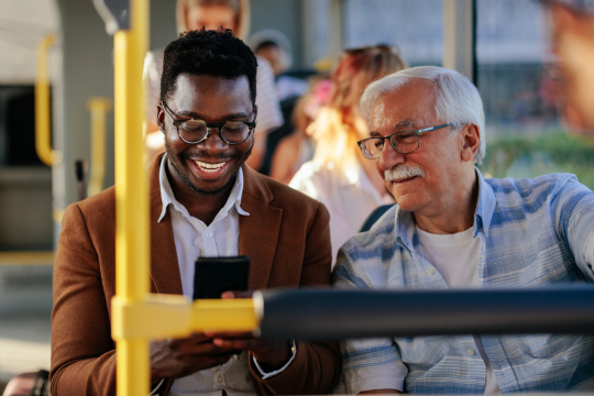 Young man with a senior man on the city bus. Young man with a senior man on the city bus.
