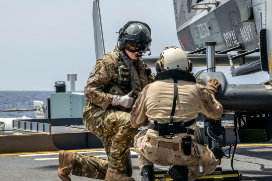 Two servicemen working on an aircraft. Two servicemen working on an aircraft.