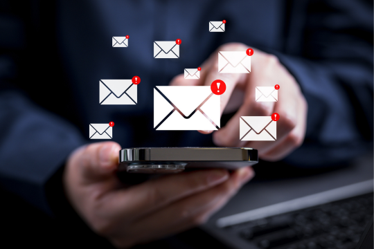 Adult man holding smartphone with excessive notifications from social media and email. 