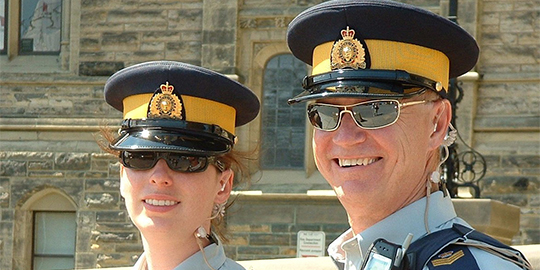 RCMP (now retired S/Sgt) Greg Williams works the Parliament Hill security detail on Canada Day 2003 with his daughter (currently Cpl) Sandra Weppler.