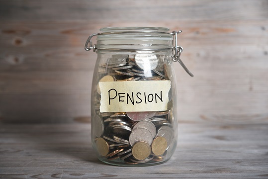 A money jar labelled with the word pension on it.