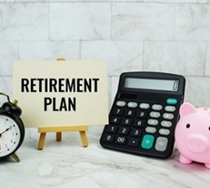 Retirement plan placard with clock, calculator and piggy bank.