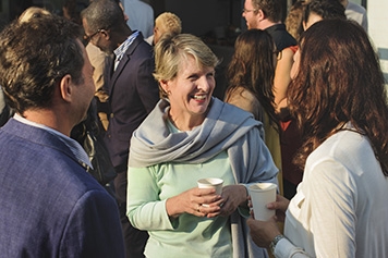 People shaking hands while networking with the Federal Retirees community