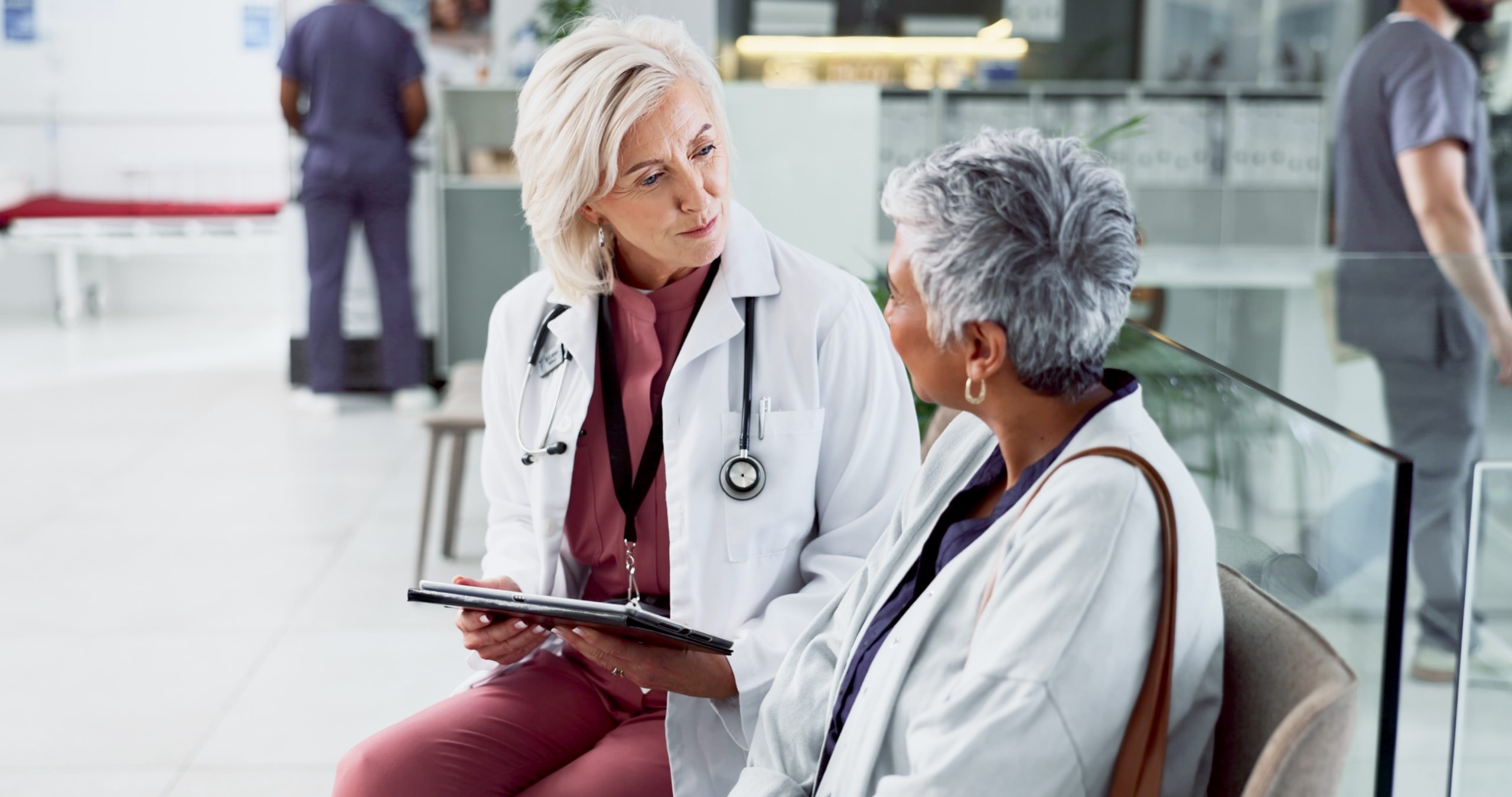 Patient adulte en consultation avec un médecin dans un milieu hospitalier.