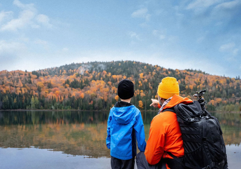 Un père et son fils regardent un lac.